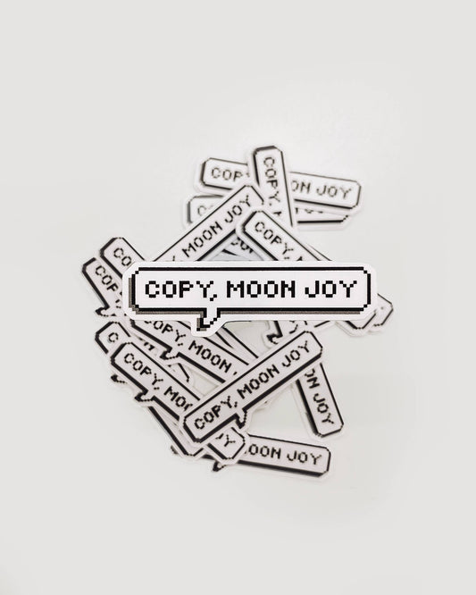 Multiple 'COPY. MOON JOY' stickers scattered on a light gray background