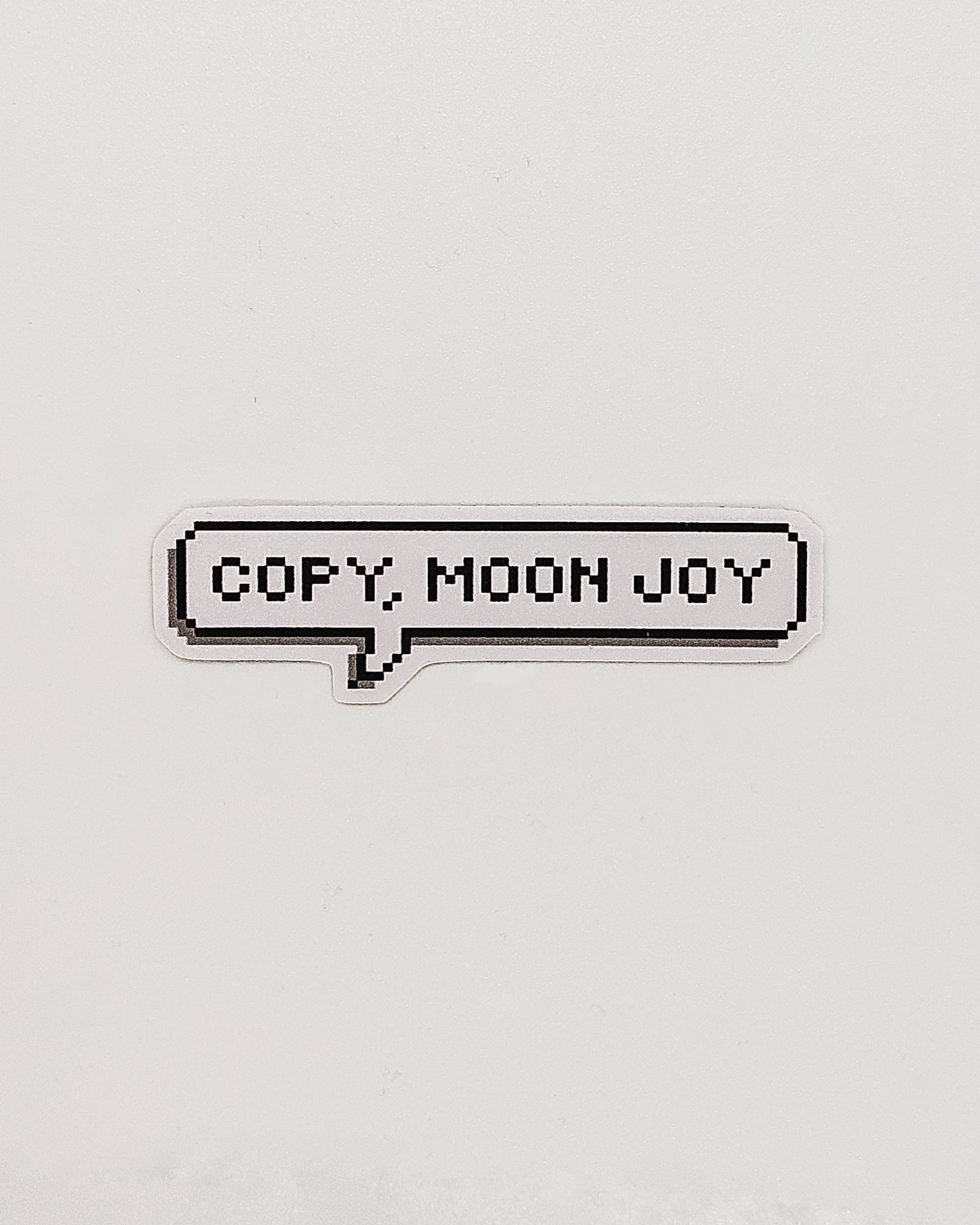 Pixel text 'COPY MOON JOY' on a light gray background